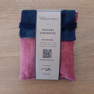 Delta Premium Select Someone Somewhere Artisan-Made Amenity Kit. Navy and Pink.